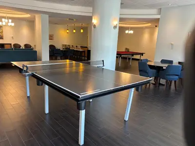a ping pong table in a room with tables and chairs at Beachfront one bedroom in the Tides in Hollywood in Hollywood