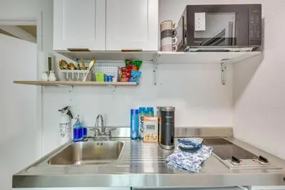 a kitchen counter with a sink and a microwave at 2 Mi to Hard Rock Stadium Studio in Miami Gardens in Miami