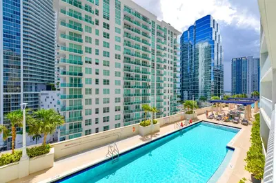 a pool on the balcony of a building with tall buildings at Elegant Retreat Brickell in Miami