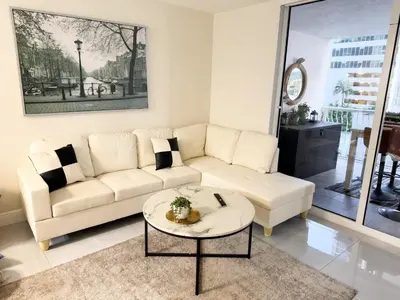 a living room with a white couch and a table at Elegant Retreat Brickell in Miami