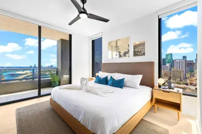a bedroom with a large bed and large windows at Enjoy Miami From a Condo on 24th Floor in Miami