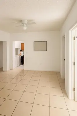 a woman standing in an empty room with a white wall at Fauna Bizcaya in Gold Coast Heliport