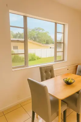 a dining room table with chairs and a bowl of fruit on it at Fauna Bizcaya in Gold Coast Heliport