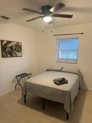 a bedroom with a bed and a ceiling fan at Fauna Bizcaya in Gold Coast Heliport
