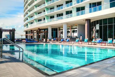 a swimming pool in front of a hotel at Luxury Beachfront Condo W Top Amenities in Hollywood