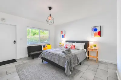 a bedroom with a bed and a chair in it at Beach and Art Close to This Lovely Studio in Miami