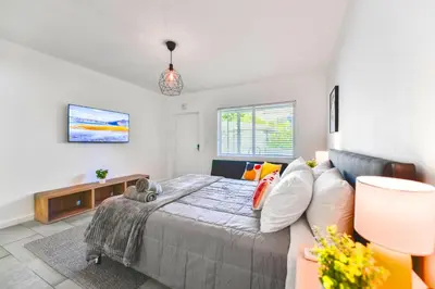a bedroom with a bed and a couch at Beach and Art Close to This Lovely Studio in Miami