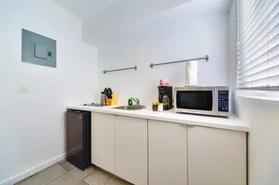 a kitchen with a counter with a microwave and a sink at Beach and Art Close to This Lovely Studio in Miami