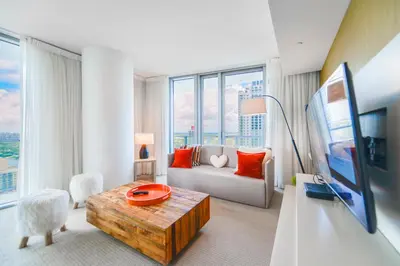 a living room with a couch and a large window at Stunning Oceanfront Escape & Luxury Resort Living in Hollywood