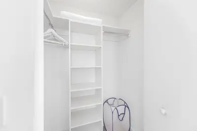 a closet with white shelves and a glass door at Stunning Oceanfront Escape & Luxury Resort Living in Hollywood