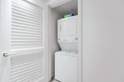 a washer and dryer in a room with a door at Stunning Oceanfront Escape & Luxury Resort Living in Hollywood