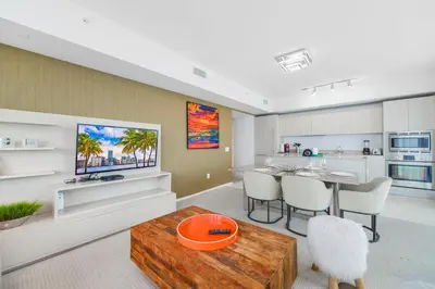 a living room with a dining table and a kitchen at Stunning Oceanfront Escape & Luxury Resort Living in Hollywood