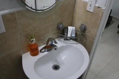 a white sink in a bathroom with a mirror at Coral Gables Guest Studio in Miami