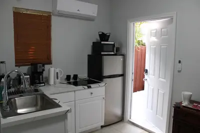 a kitchen with a sink and a refrigerator at Coral Gables Guest Studio in Miami