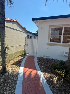 a brick walkway in front of a house at Coral Gables Guest Studio in Miami