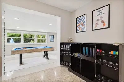 a games room with a pool table in the middle at The Jungalo Pool & Billards in Fort Lauderdale