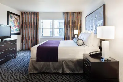 a hotel room with a large bed and a television at Solara Surfside in Miami Beach