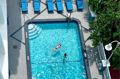 an overhead view of a person swimming in a swimming pool at Solara Surfside in Miami Beach