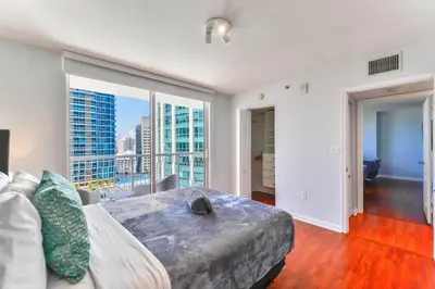 a bedroom with a bed and a large window at Upscale Condo in Brickell in Miami
