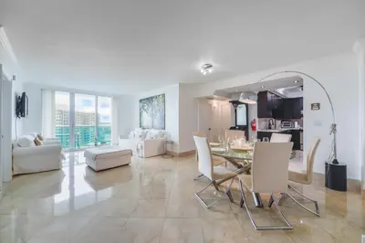 a living room with a table and a dining room at Hollywood Beachfront Retreat in Hollywood