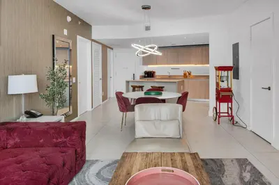 a living room with a red couch and a table at Ventur Luxe Condo - Oceanview - Gym, Beach Access in Hollywood