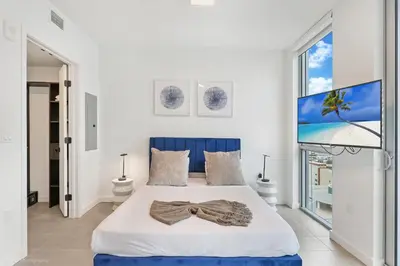 a bedroom with a bed and a large window at Modern Luxe Studio in Downtown Miami with Rooftop Pool and Gym in Miami