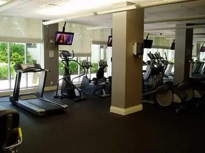 a gym with several exercise bikes in a room at Direct access to the beach, pool and parking 3T in Hollywood