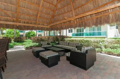 an outdoor patio with furniture and a wooden roof at Direct access to the beach, pool and parking 3T in Hollywood
