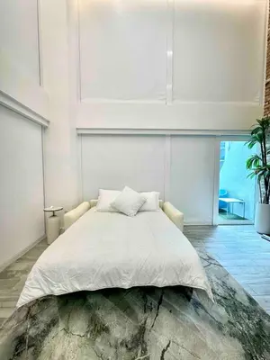 a white bedroom with a large bed and a large window at LOFT Brickell River 10 min To South Beach in Miami