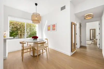 a white dining room with a table and chairs at Lux Designer Apt 2BR and 2BA in the Heart of MIA Beach in Miami Beach
