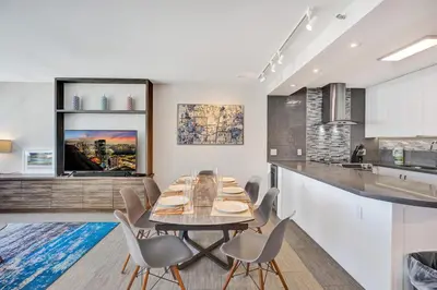 a kitchen and dining room with a table and chairs at Luxury Condo with Resort Amenities Pools Gym and Sauna 804 in Miami Beach