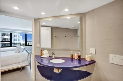 a bathroom with a sink and a mirror at Luxury Condo with Resort Amenities Pools Gym and Sauna 804 in Miami Beach