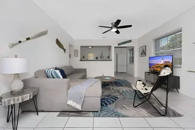 a living room with a couch and a tv at The Palm House in Hollywood