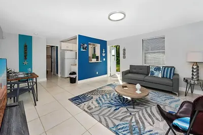 a living room with a couch and a table at Ocean Breeze Home in Hollywood