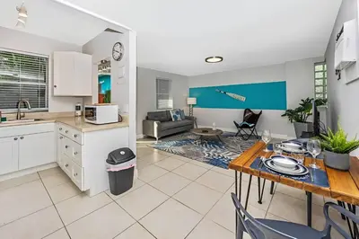 a kitchen and living room with a table and a dining room at Ocean Breeze Home in Hollywood