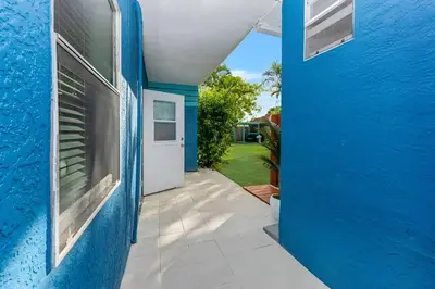 a blue house with a blue wall and a door at Ocean Breeze Home in Hollywood