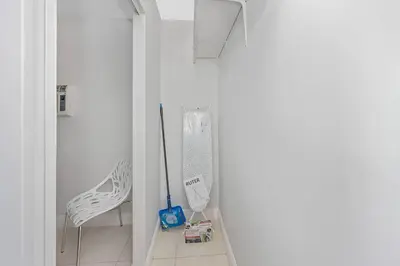 a room with a toothbrush and a white chair at Ocean Breeze Home in Hollywood