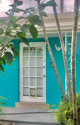 a blue house with a white door at Luna Beach House in Hollywood