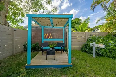 a gazebo with chairs and a table in a yard at Luna Beach House in Hollywood