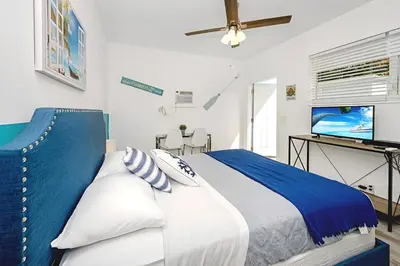 a bedroom with a bed and a flat screen tv at Blue Coral Studio in Hollywood