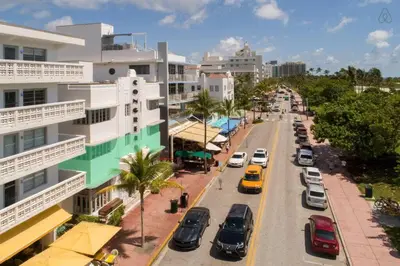 a city street with cars parked on the road at Oceanfront Oasis 2-BR Apartment on Ocean Drive in Miami Beach