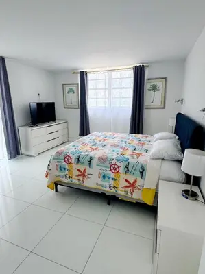 a bedroom with a bed and a television in it at Ocean view-Large 2bedroom Remodeled on the beach in Hollywood