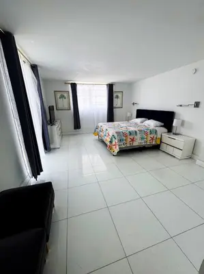 a bedroom with a bed and a white tiled floor at Ocean view-Large 2bedroom Remodeled on the beach in Hollywood