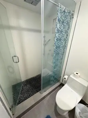a bathroom with a toilet and a glass shower at Ocean view-Large 2bedroom Remodeled on the beach in Hollywood