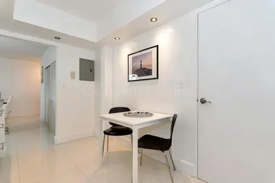 a white table and two chairs in a room at Hollywood Beach, 10th floor, on the beach 10T in Hollywood