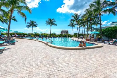 a swimming pool at a resort with palm trees at Hollywood Beach, 10th floor, on the beach 10T in Hollywood