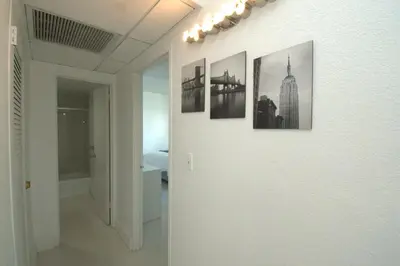 a hallway with four pictures on a wall at Hollywood Beach, 10th floor, on the beach 10T in Hollywood