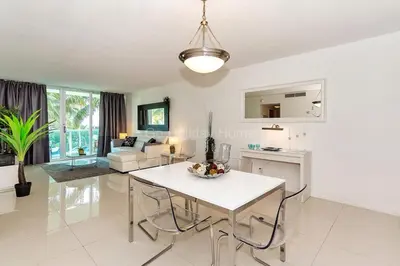 a kitchen and living room with a table and chairs at Ocean front, full equiped, pool and parking 2M in Hollywood