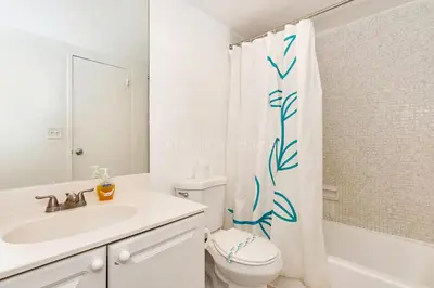 a bathroom with a toilet and a sink and a shower curtain at Ocean front, full equiped, pool and parking 2M in Hollywood