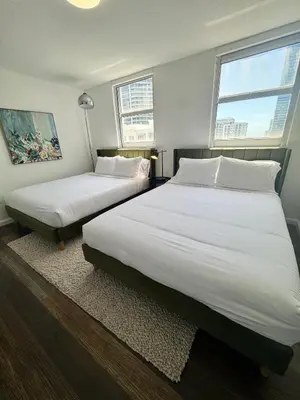 a bedroom with two beds and two windows at Brickell 2 bedroom condo in the heart of Miami in Miami